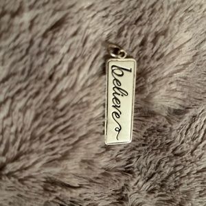 ‘Believe’ on one side, ‘Be patient, Be gentle, Be humble, Be loving’ charm